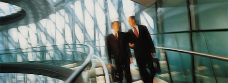 two businessmen walking down a set of stairs