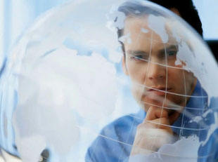 a man looking pensive behind a transparent globe